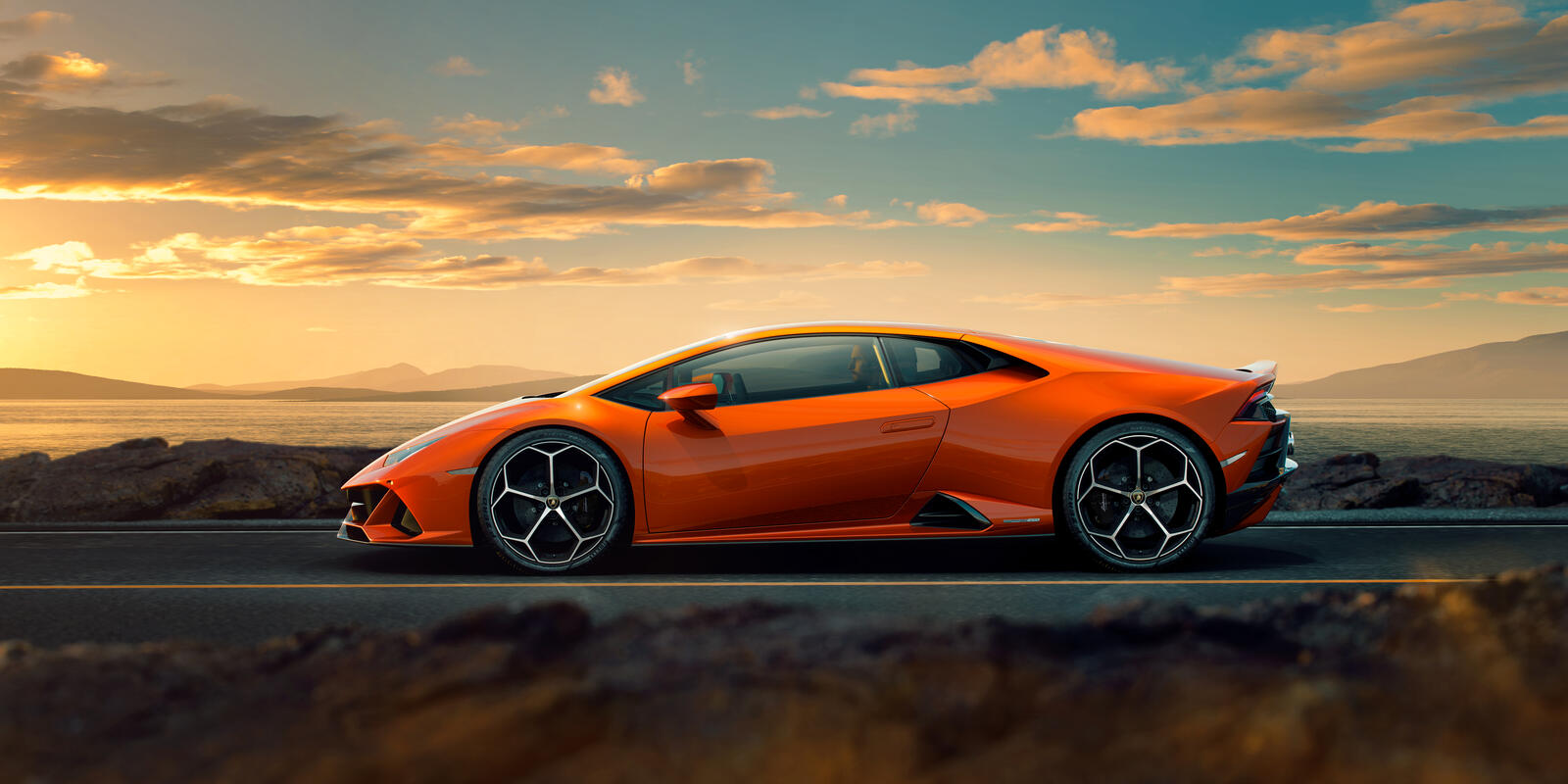 Wallpapers Lamborghini Huracan Evo orange car side view on the desktop