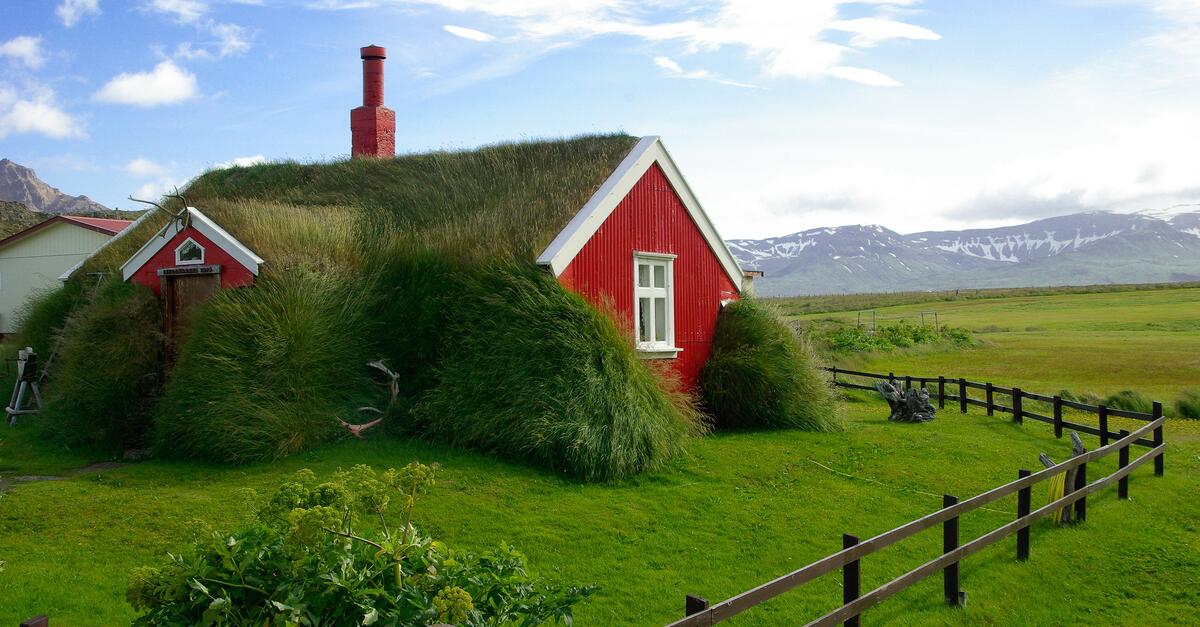 A red house with a green lawn