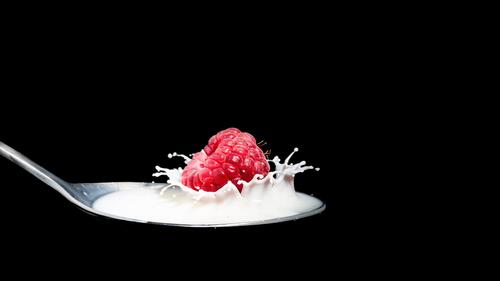 A spoonful of yogurt and raspberries