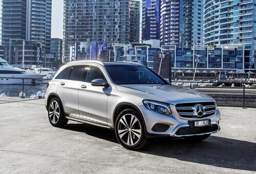 Mercedes benz glc in front of the houses