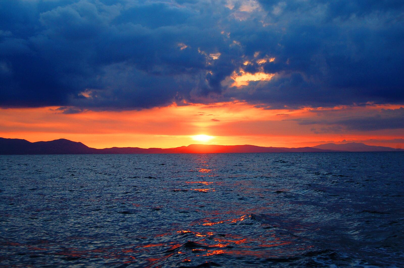 Бесплатное фото Солнечный закат в плохую погоду на море