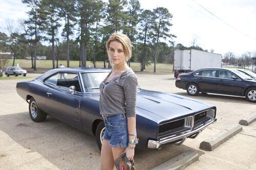 Amber Heard in front of a vintage car
