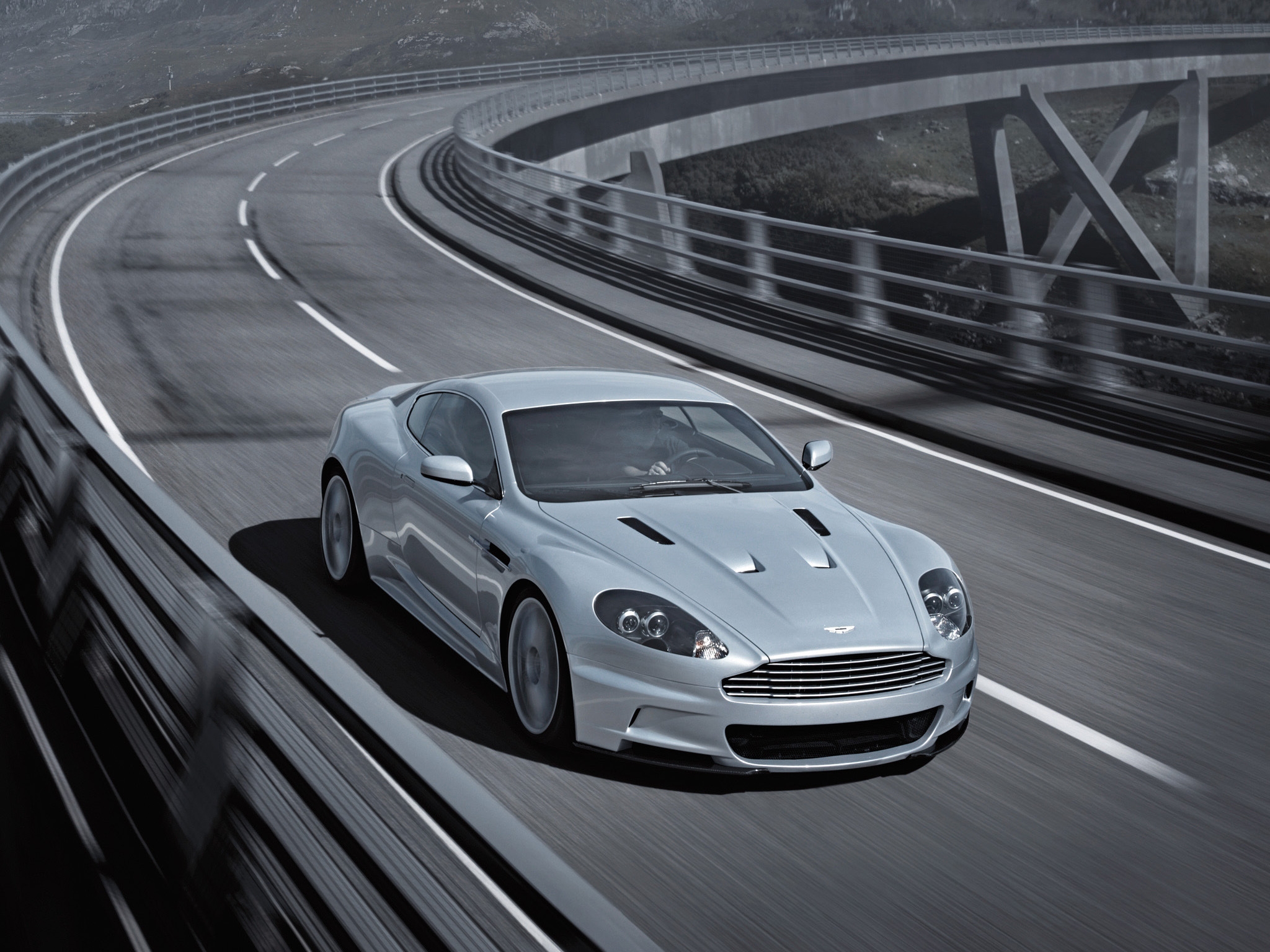 Free photo The Aston Martin Vanquish is driving on a country track.