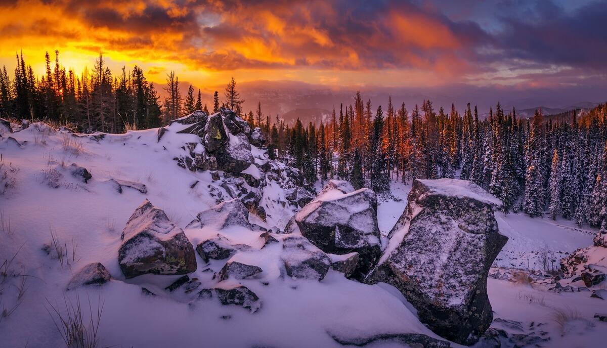Sunset at a winter quarry in the forest