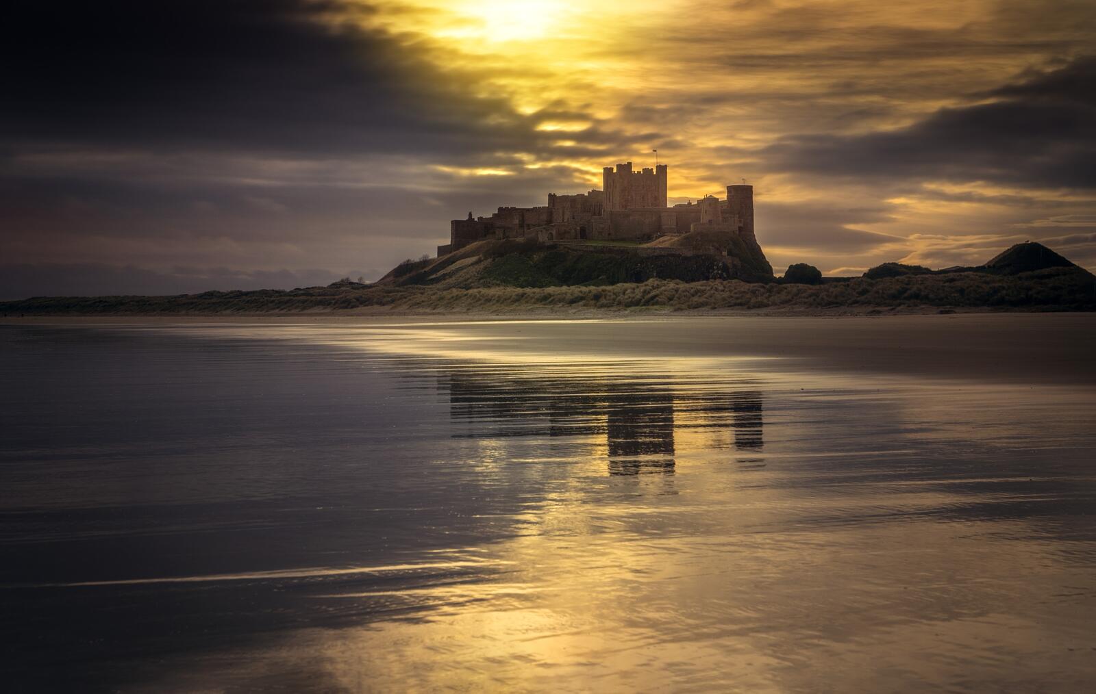 Free photo A Castle by the Sea at Sunset