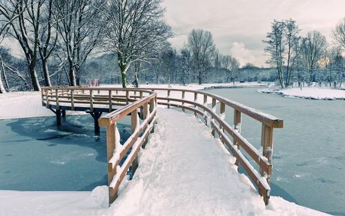 Winter bridge over a frozen river