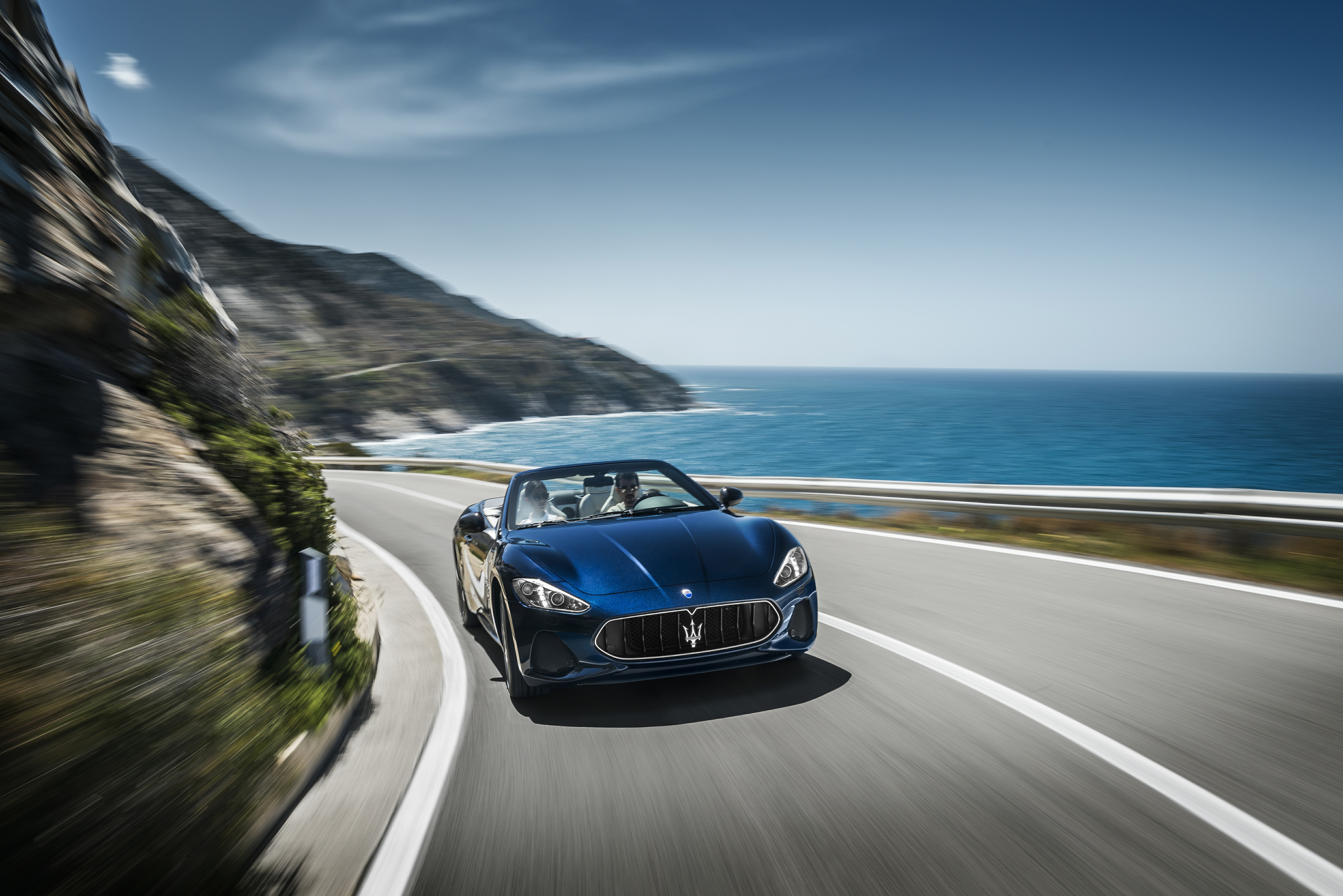 The Maserati Grancabrio drives against the backdrop of the sea