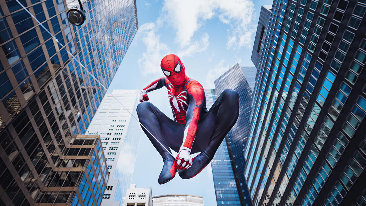 Spider-Man flies between high-rise buildings