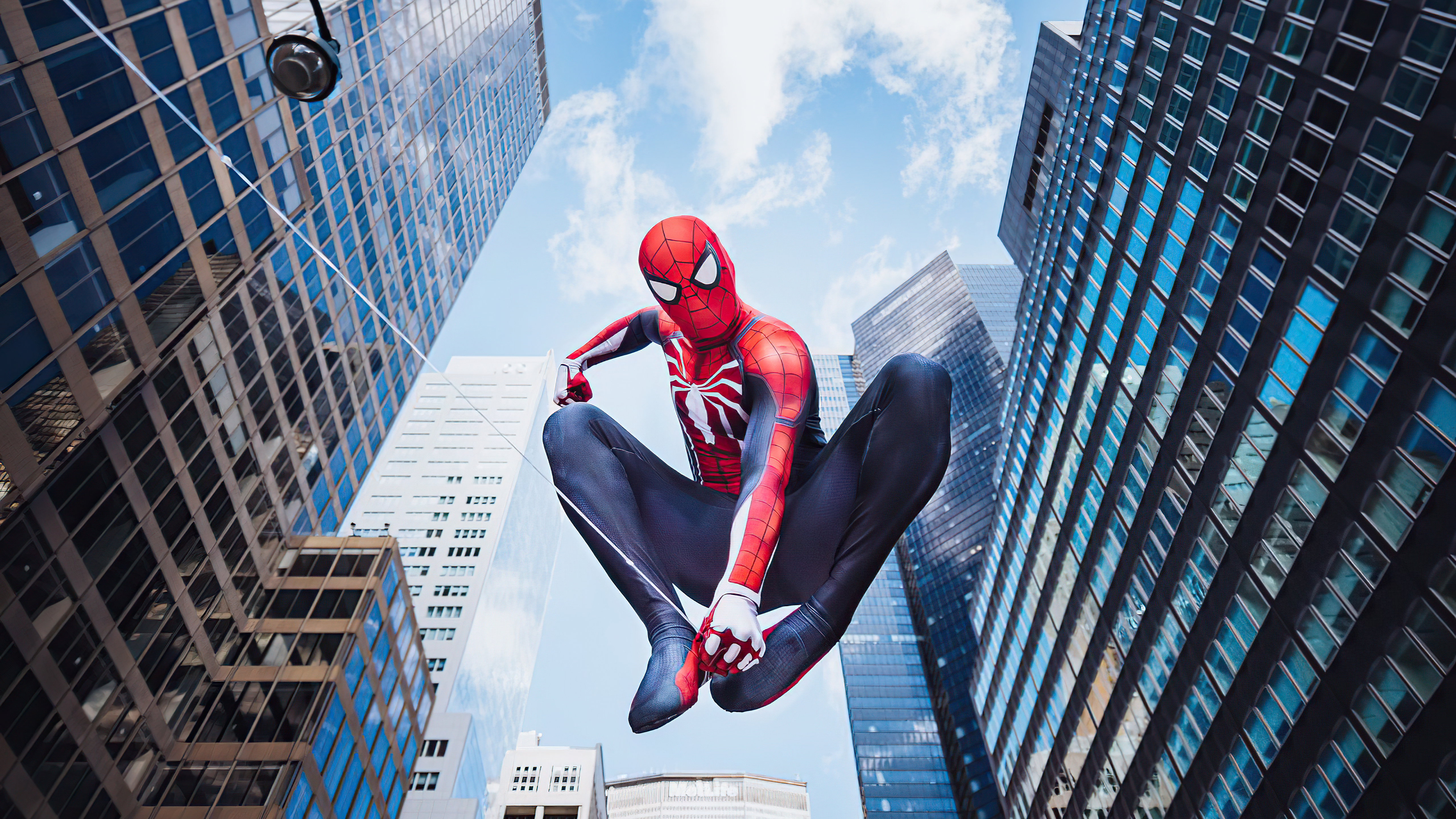 Free photo Spider-Man flies between high-rise buildings