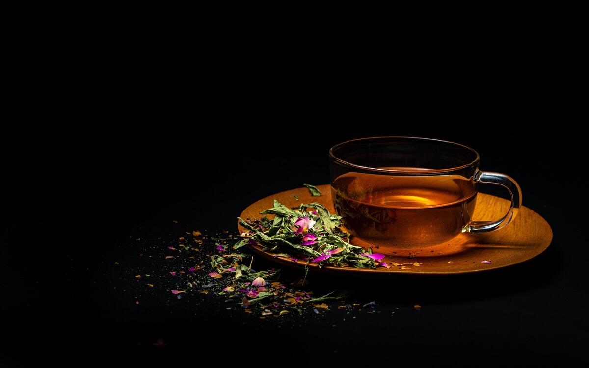 A cup of tea and a medicinal herb.