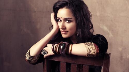 Shraddha Kapoor sits on a chair