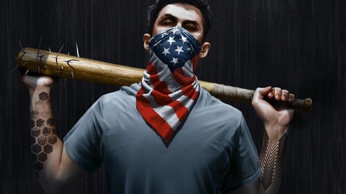 A guy with a bat wearing an American flag mask