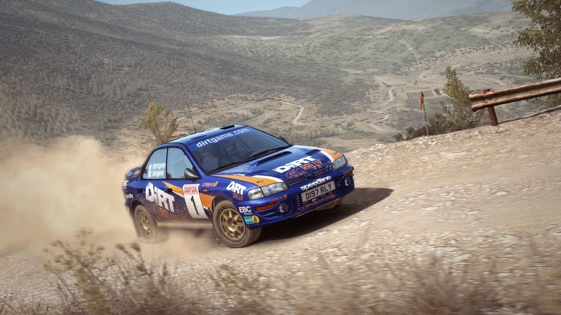 A Subaru rally car driving through the dust.