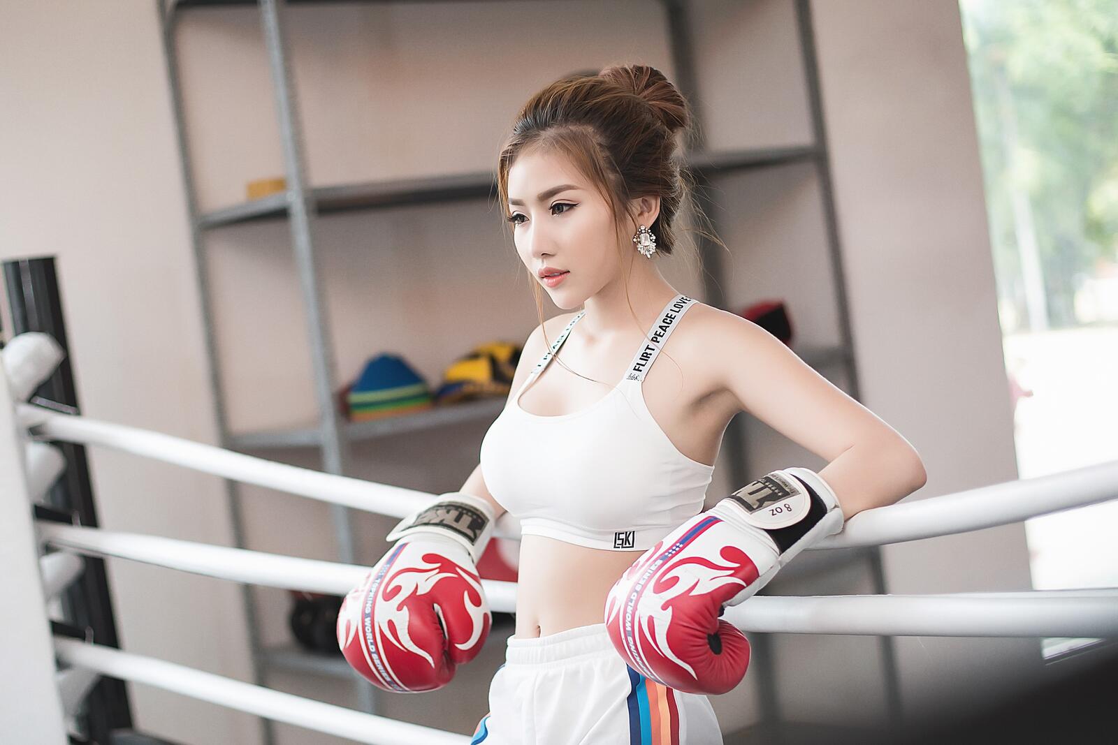 Free photo Asian boxer in gloves