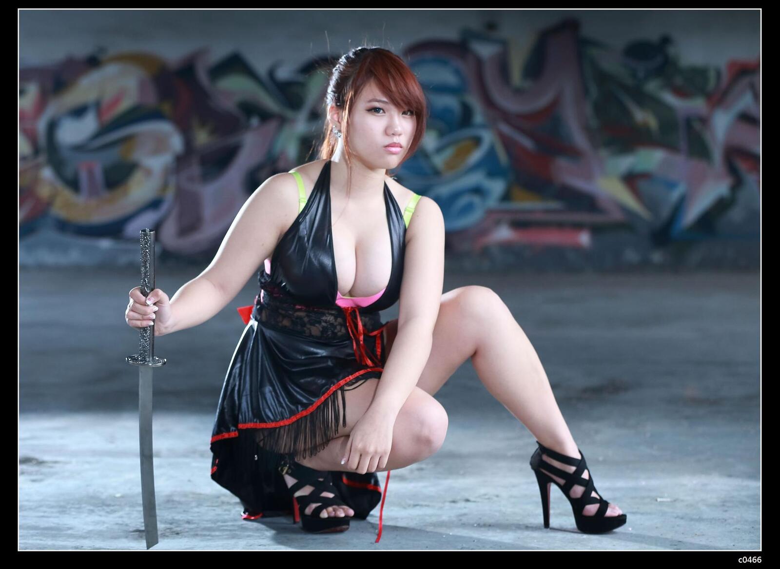 Free photo The girl with the katana in the leather dress