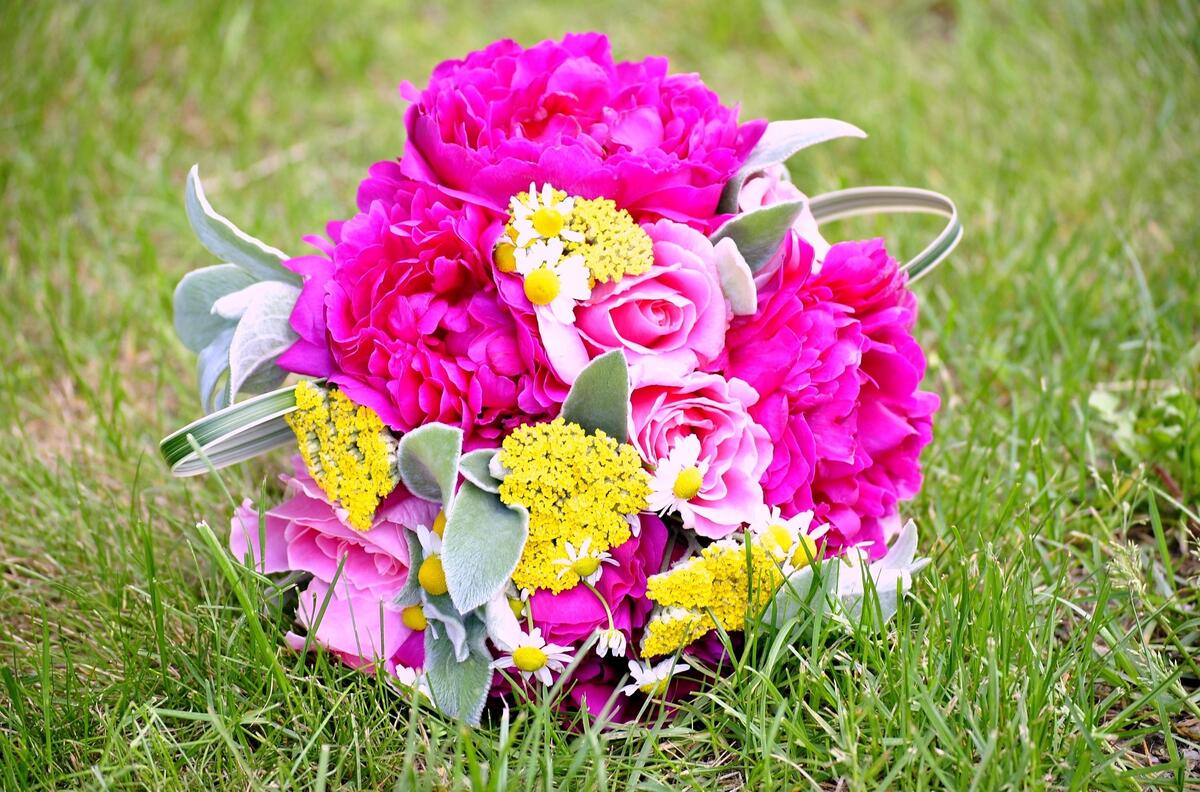 A beautiful bouquet with peonies on the grass