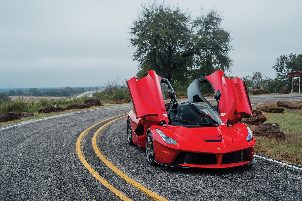A red Laferrari with the doors open.