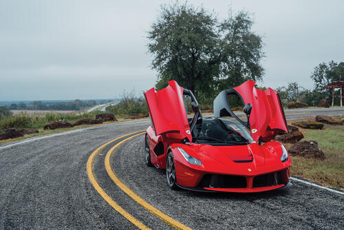 A red Laferrari with the doors open.