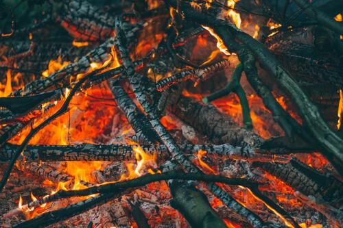 Wallpaper with smoldering branches in a bonfire