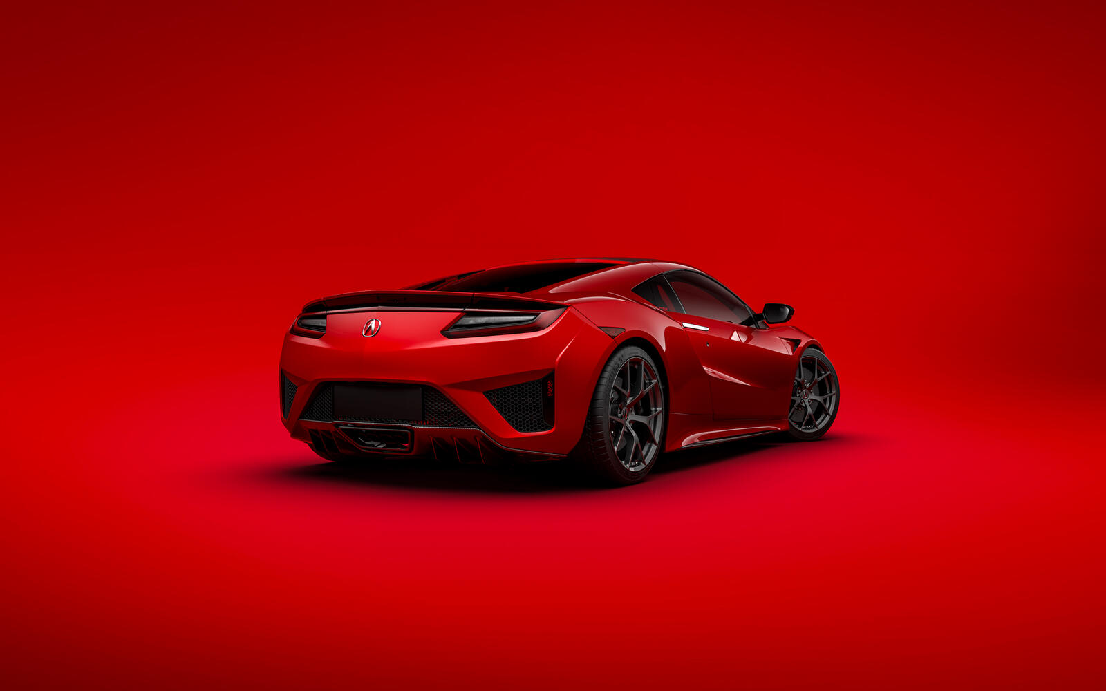 Красная Acura на красном фоне вид сзади