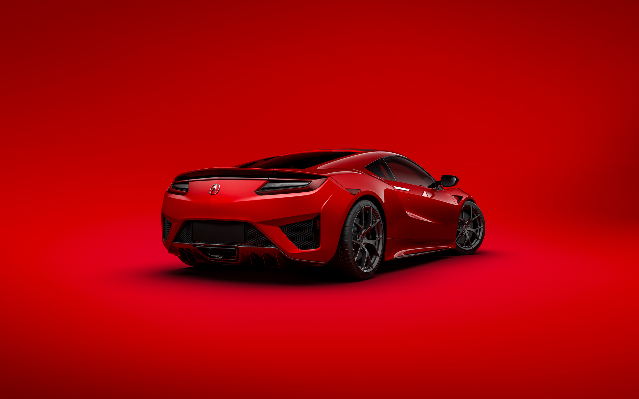 Бесплатное фото Красная Acura на красном фоне вид сзади