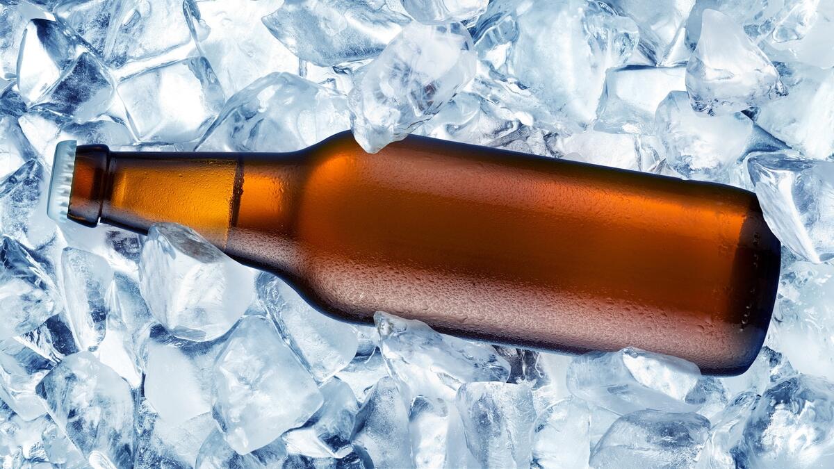 A bottle of beer in ice cubes.
