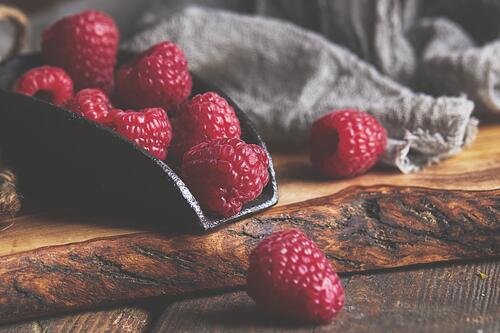 Raspberries scattered on the table