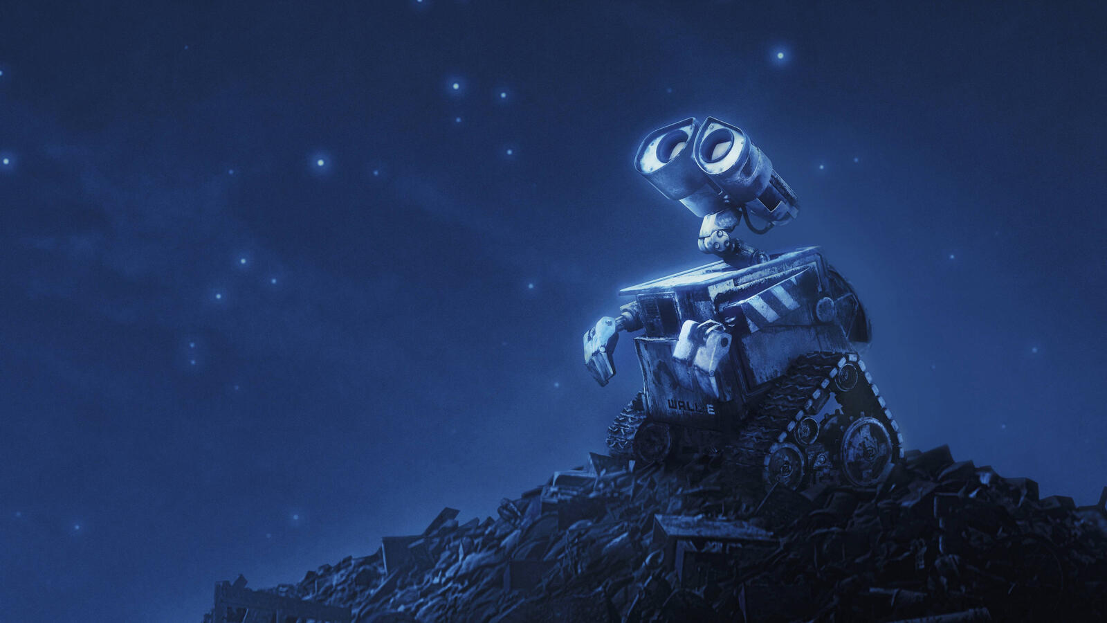 Бесплатное фото Робот вайли в ночи стоит на куче мусора