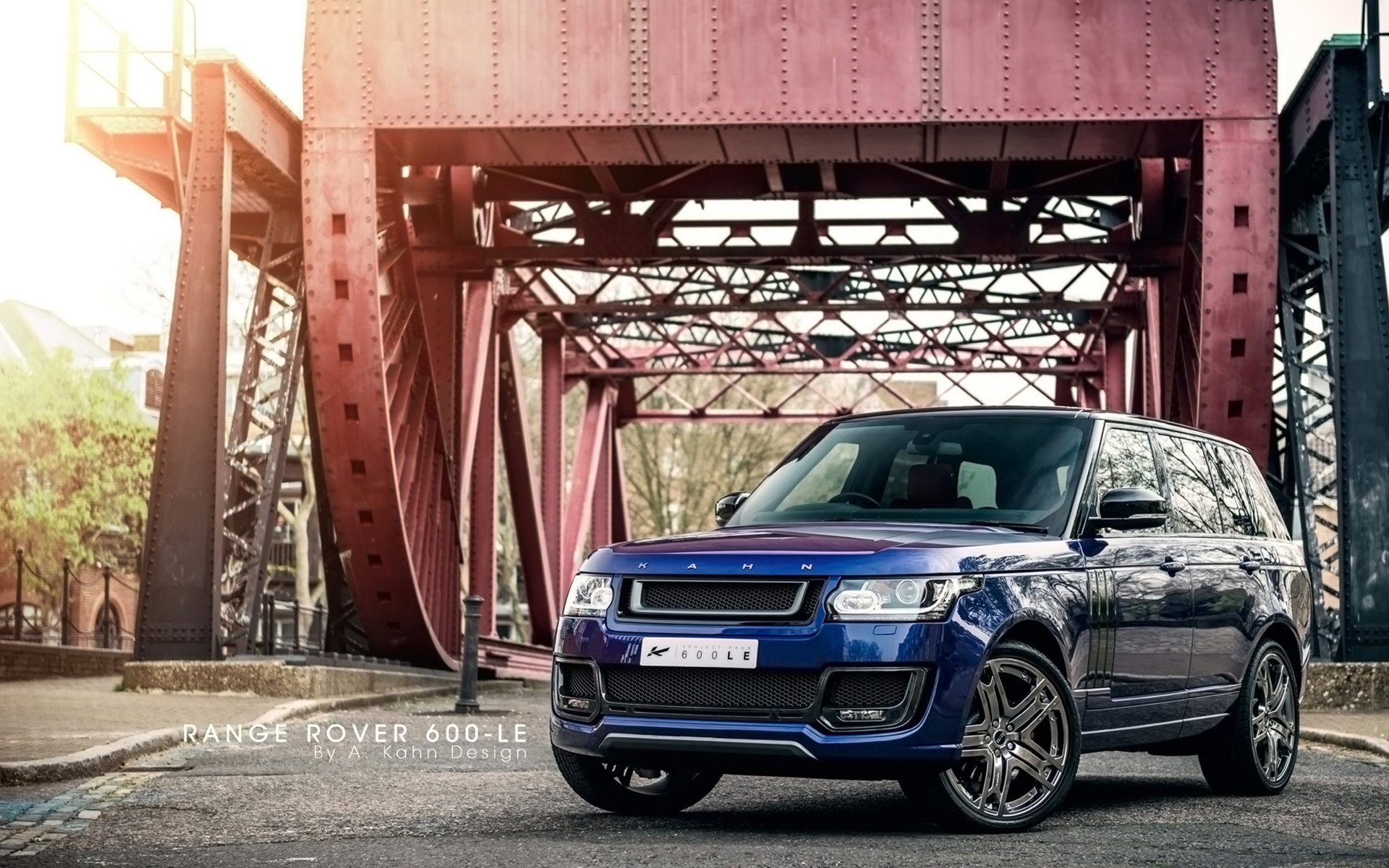 A picture of a blue Range Rover on a bridge.
