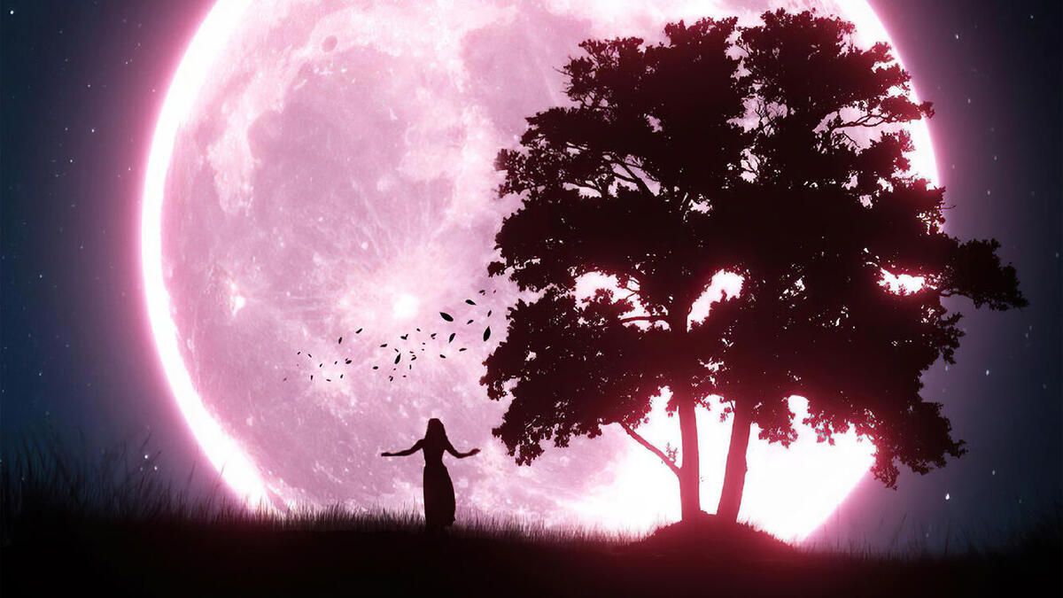A silhouette of a dancing girl against a large moon.
