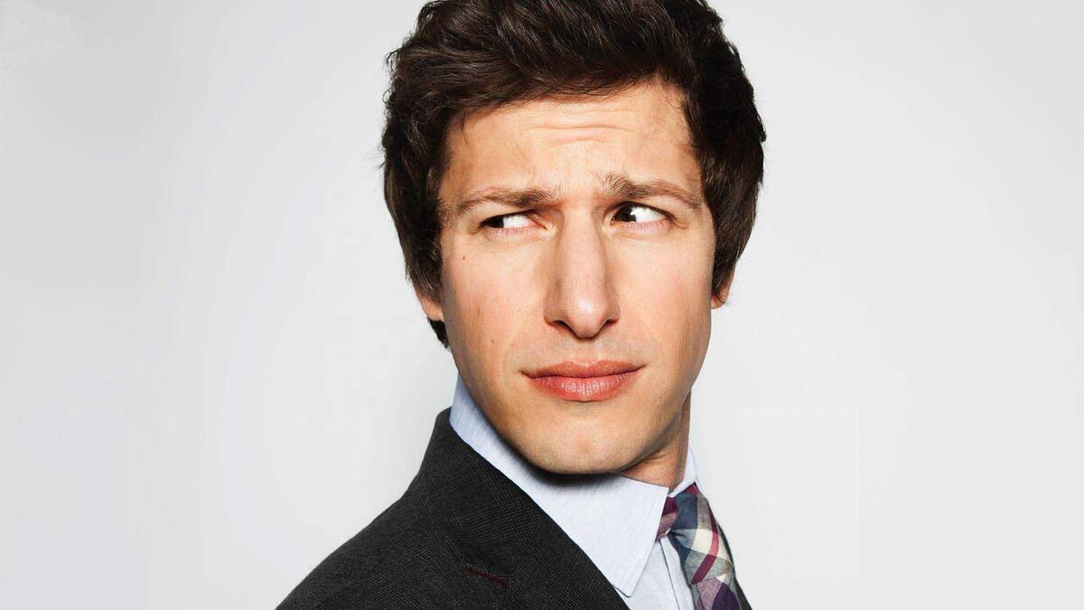 Andy Samberg in an office suit