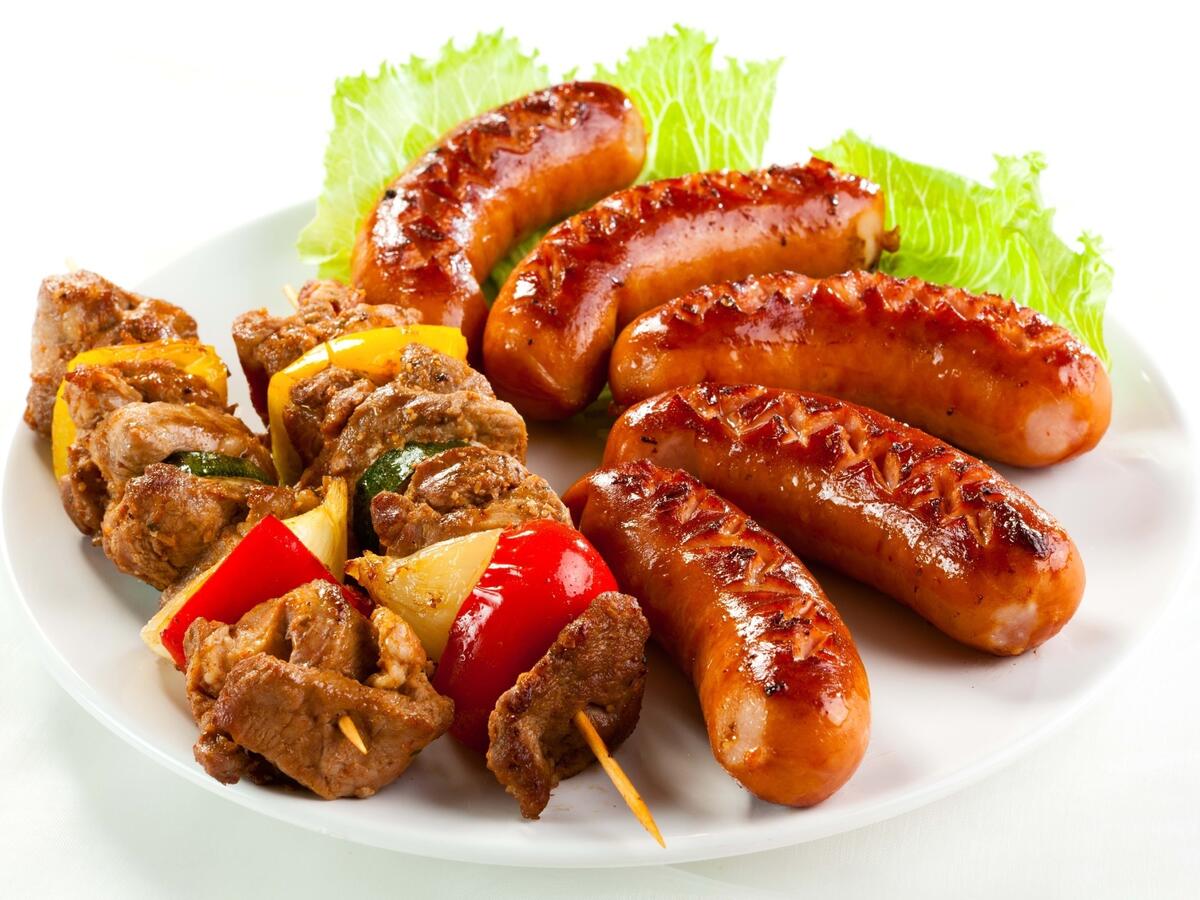 Deep-fried sausages with kebab on a white plate