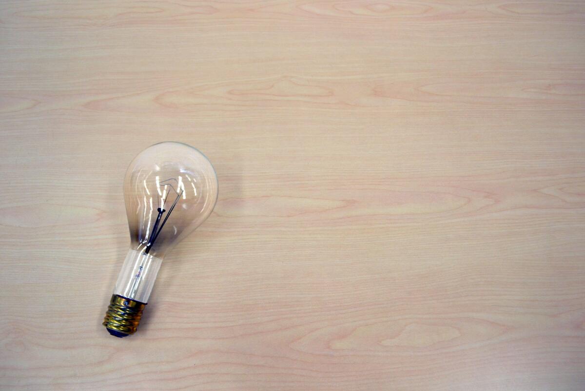 A burnt bulb on a wooden background