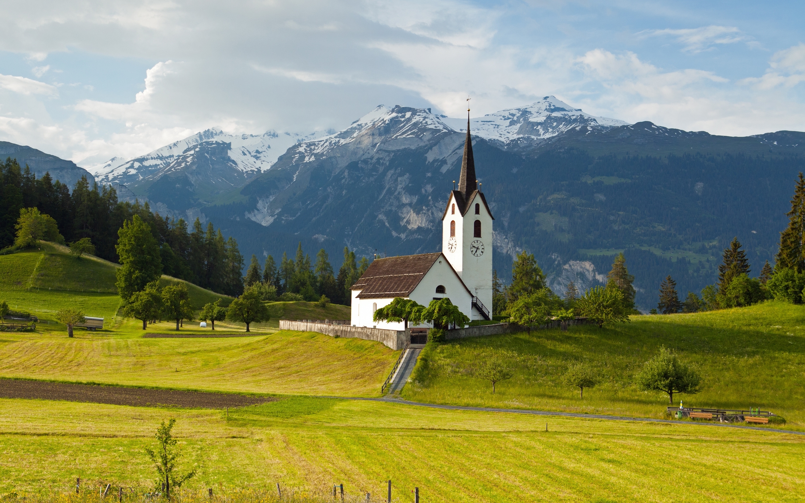 Free photo Church on a green field in Switzerland