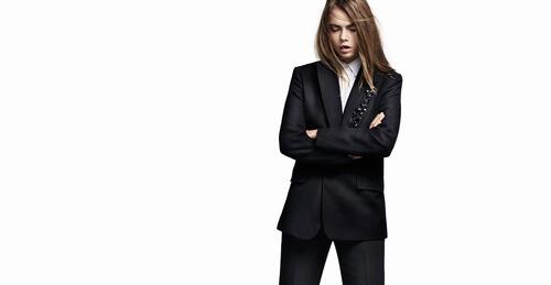 Cara Delevingne in a black suit.