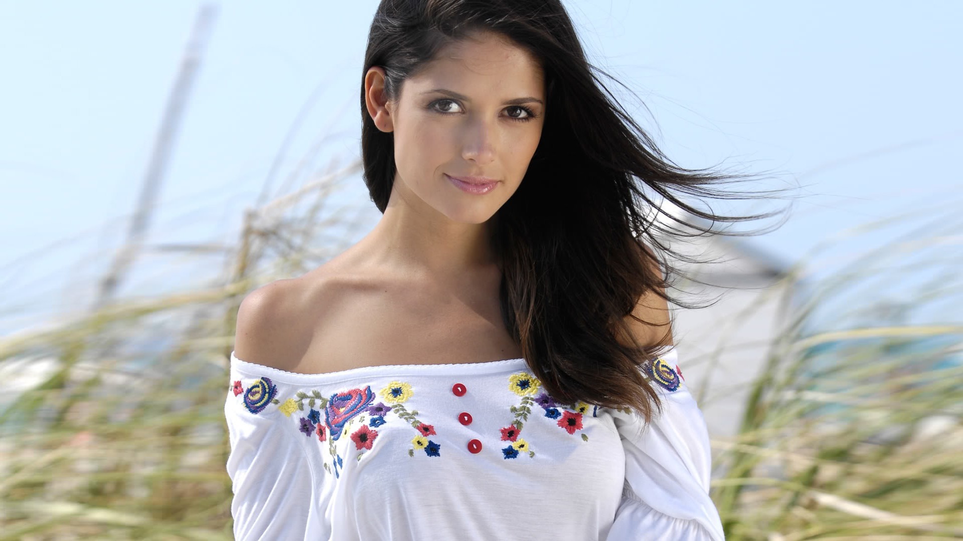 Carla Ossa in a white blouse.