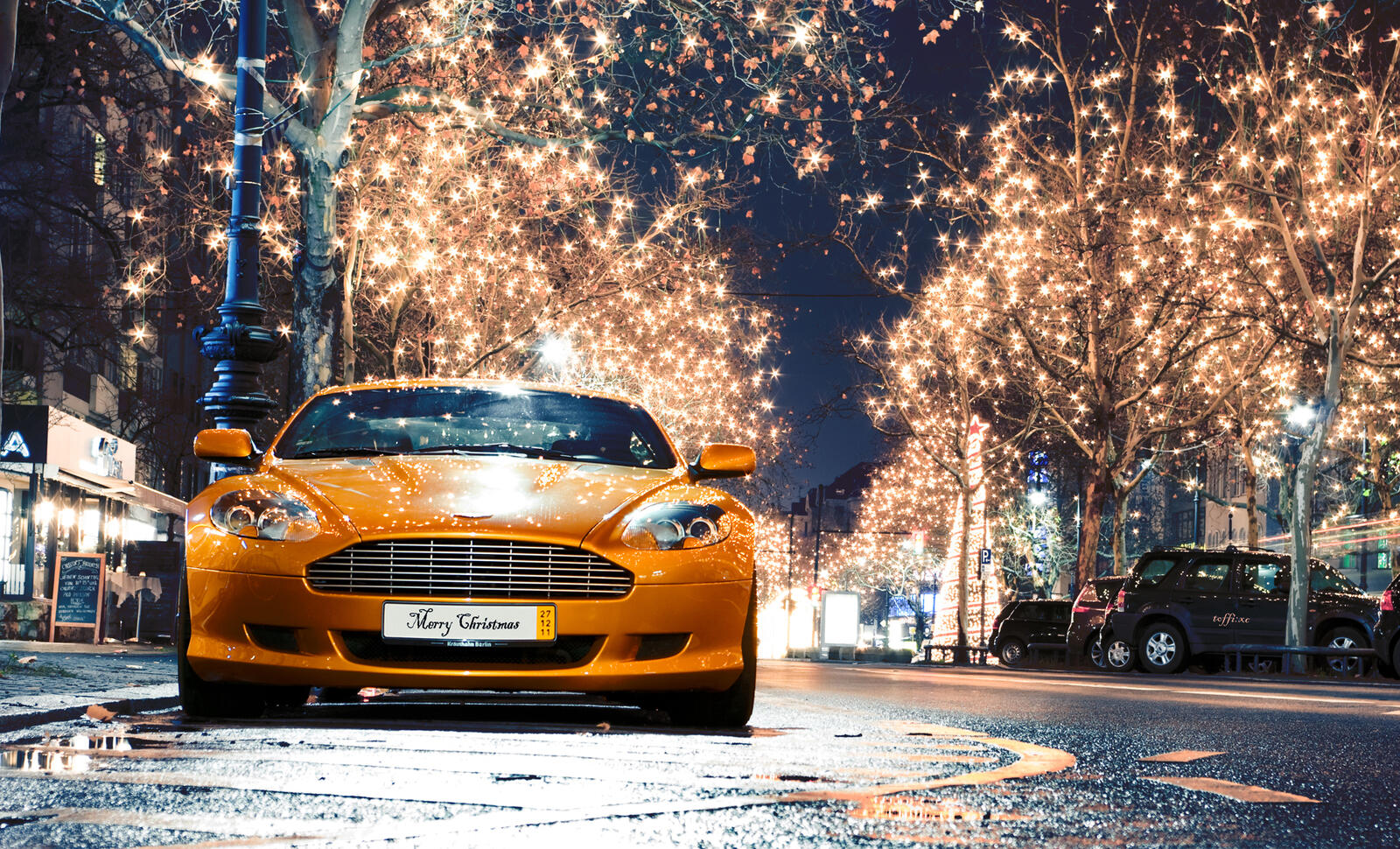 Free photo Aston Martin on the New Year`s Eve avenue