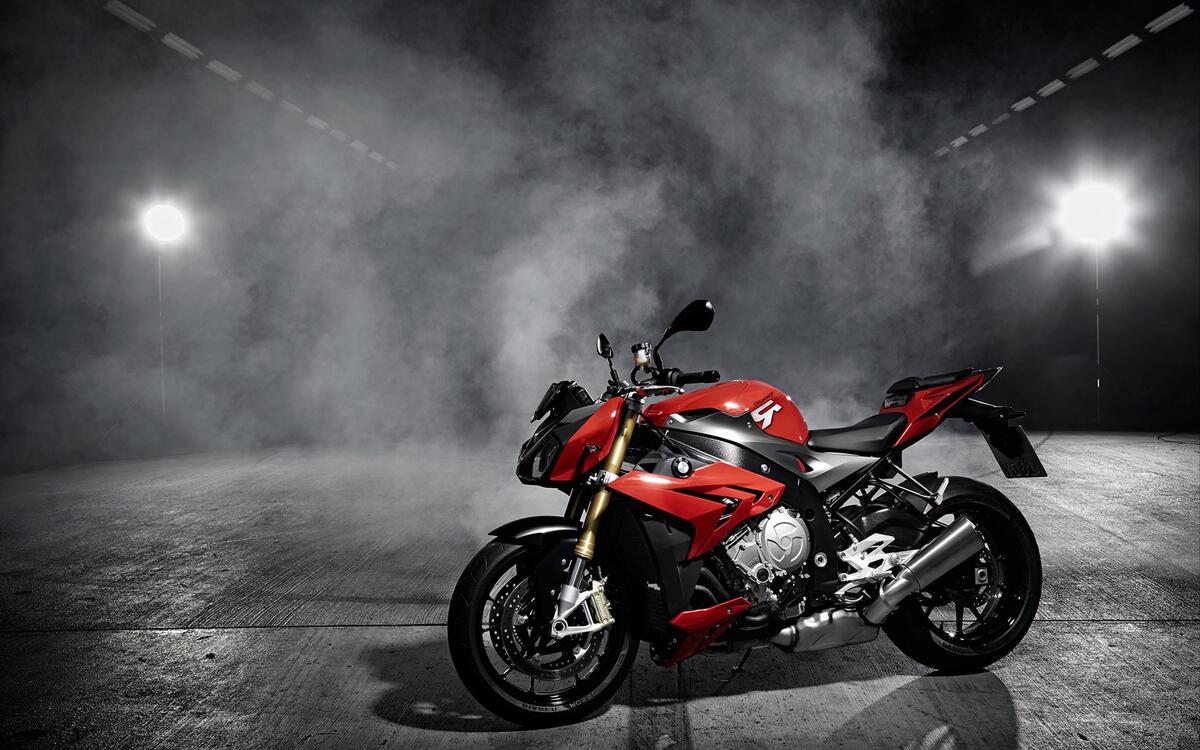 A red BMW motorcycle in the smoke