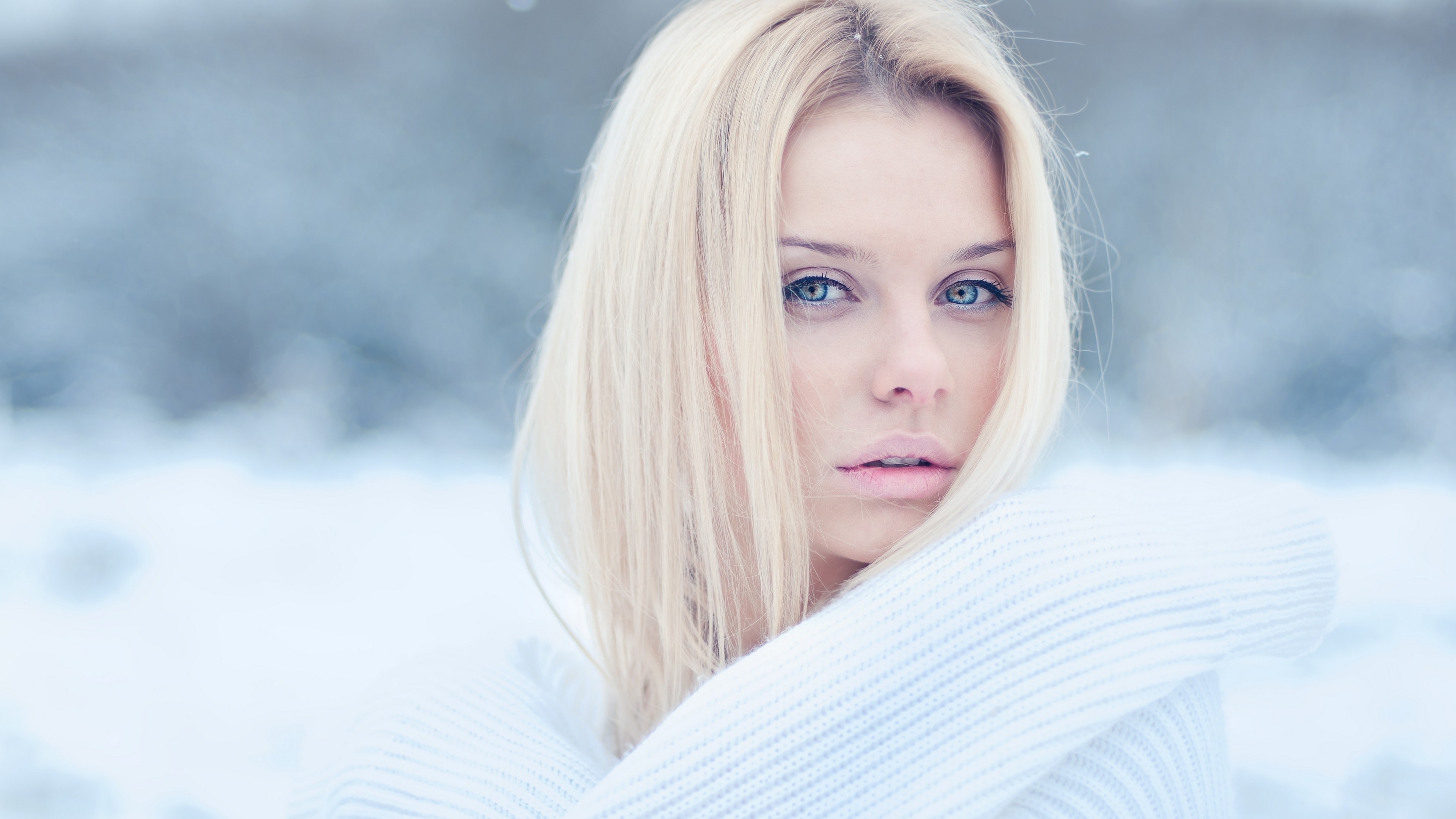 A blonde-haired girl in a white turtleneck.